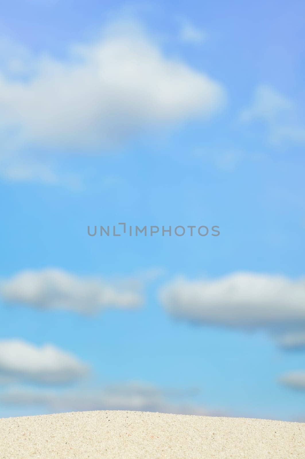 beach and blue sky in background. Focus on the sand