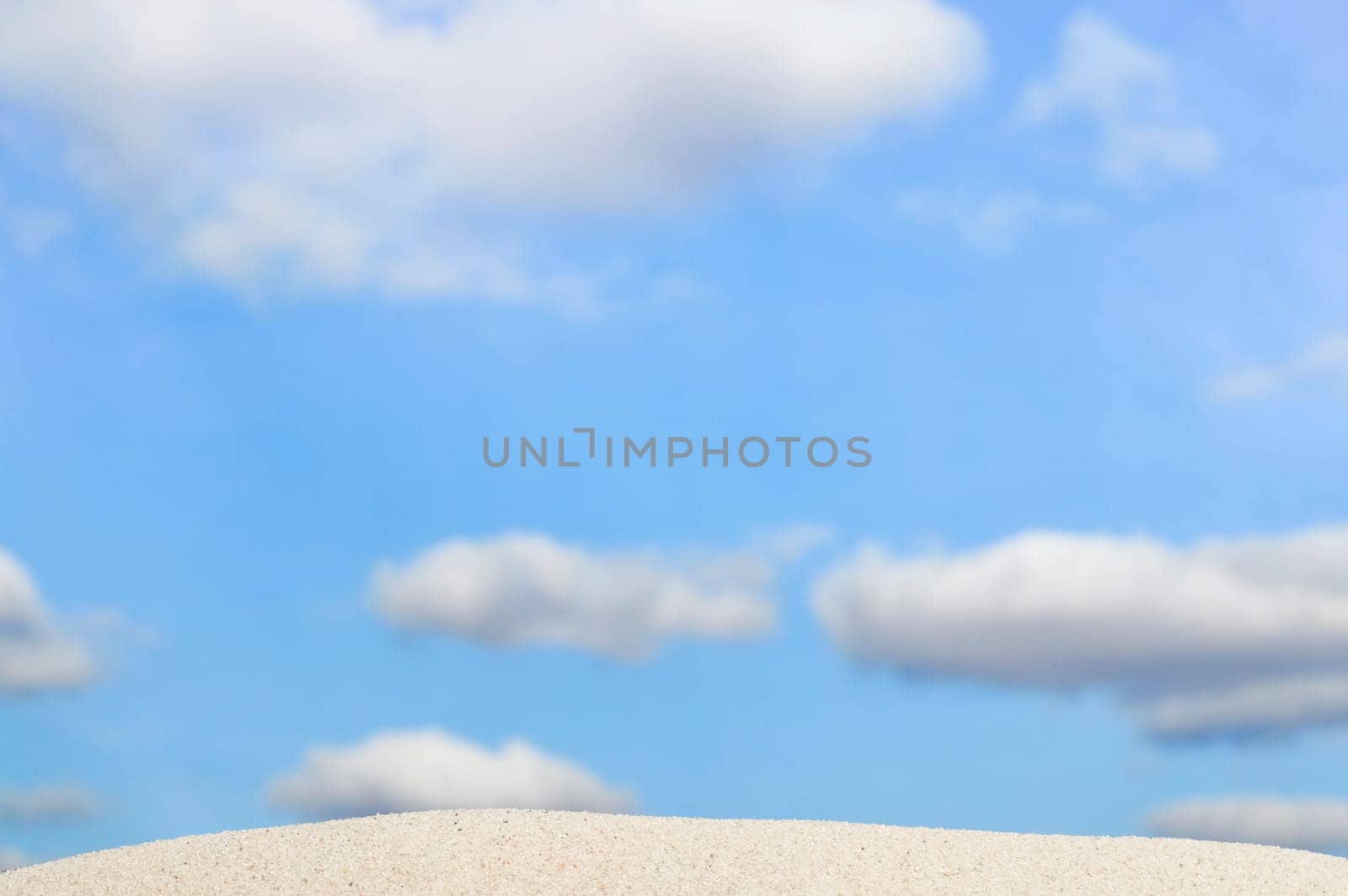 beach and blue sky in background. Focus on the sand