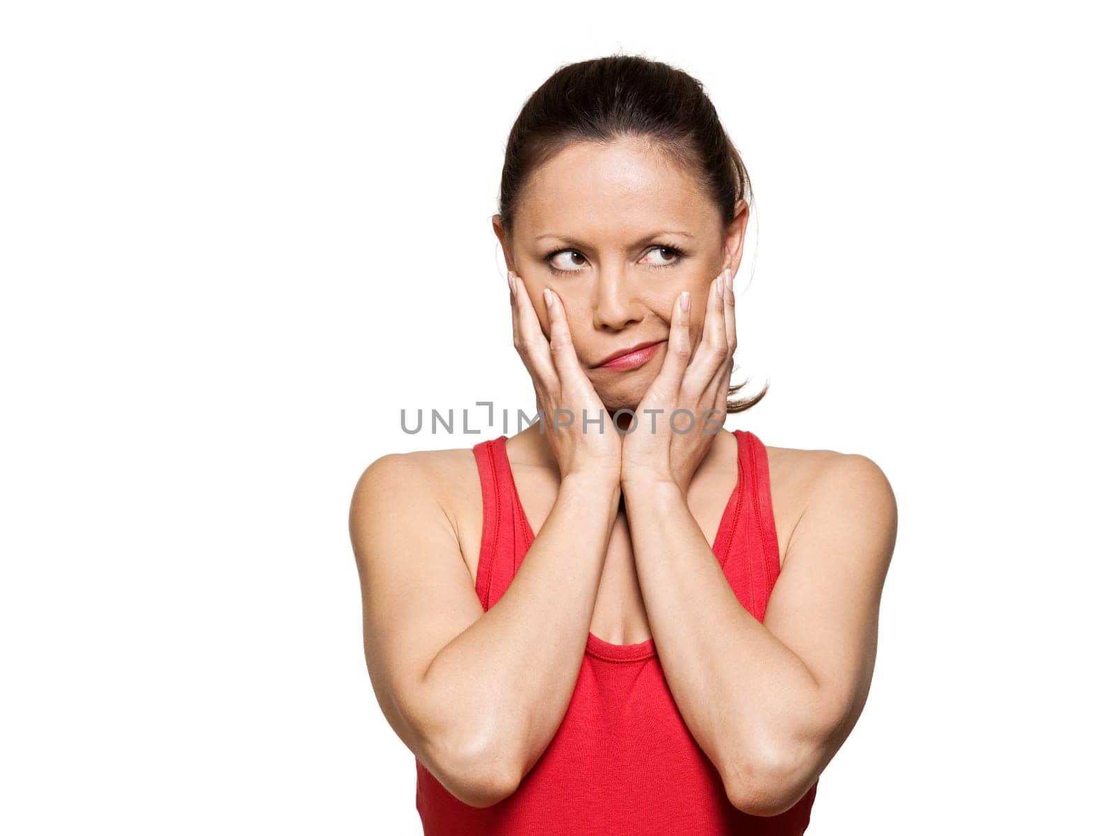 Portrait of expressive pensive woman puckering while looking away in studio isolated on white background