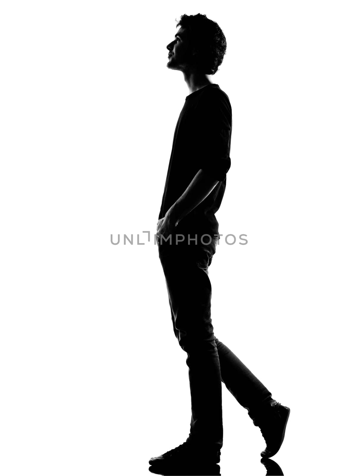 young man  walking happy smiling silhouette in studio isolated on white background
