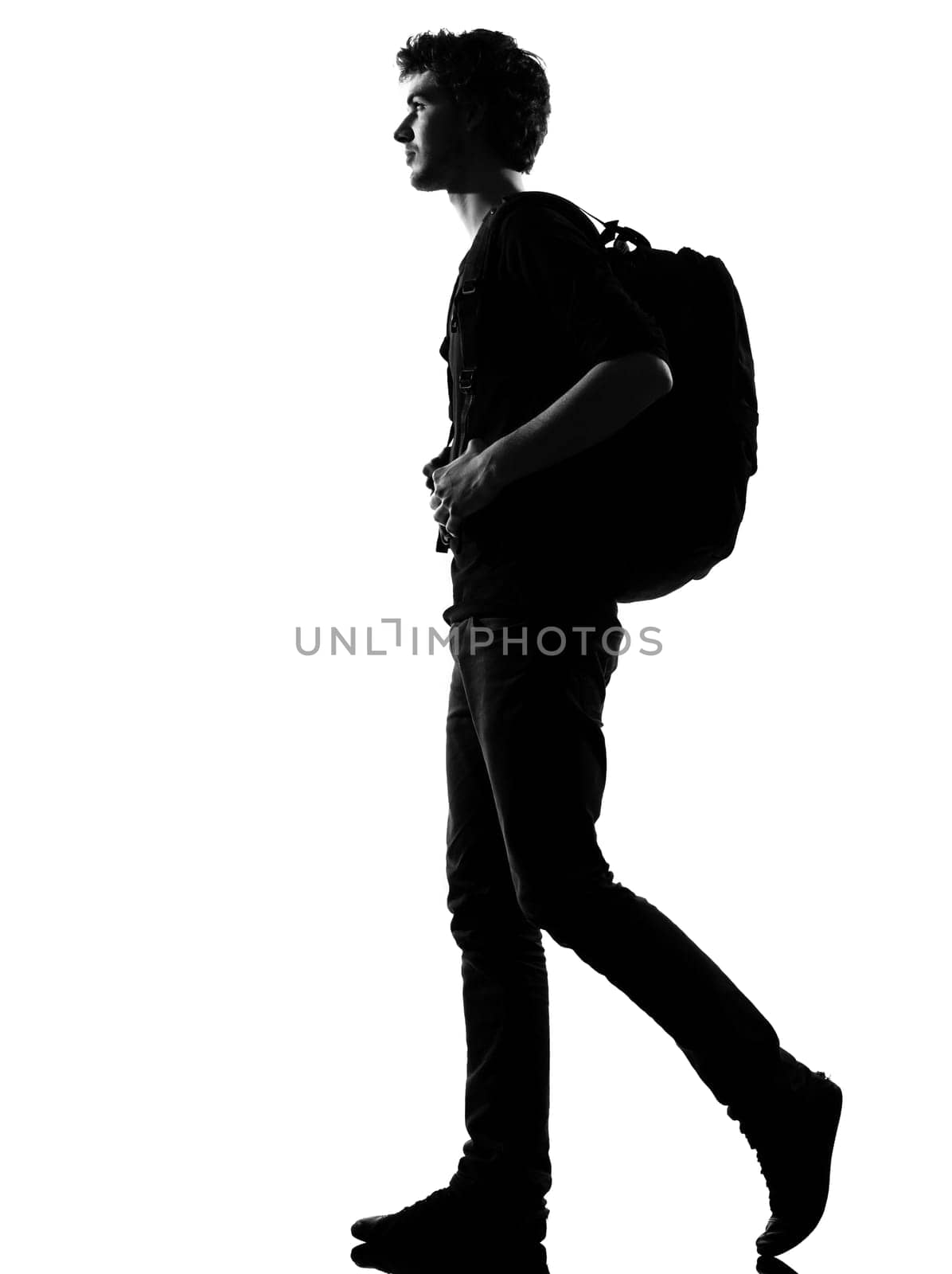 young man backpacker walking silhouette in studio isolated on white background