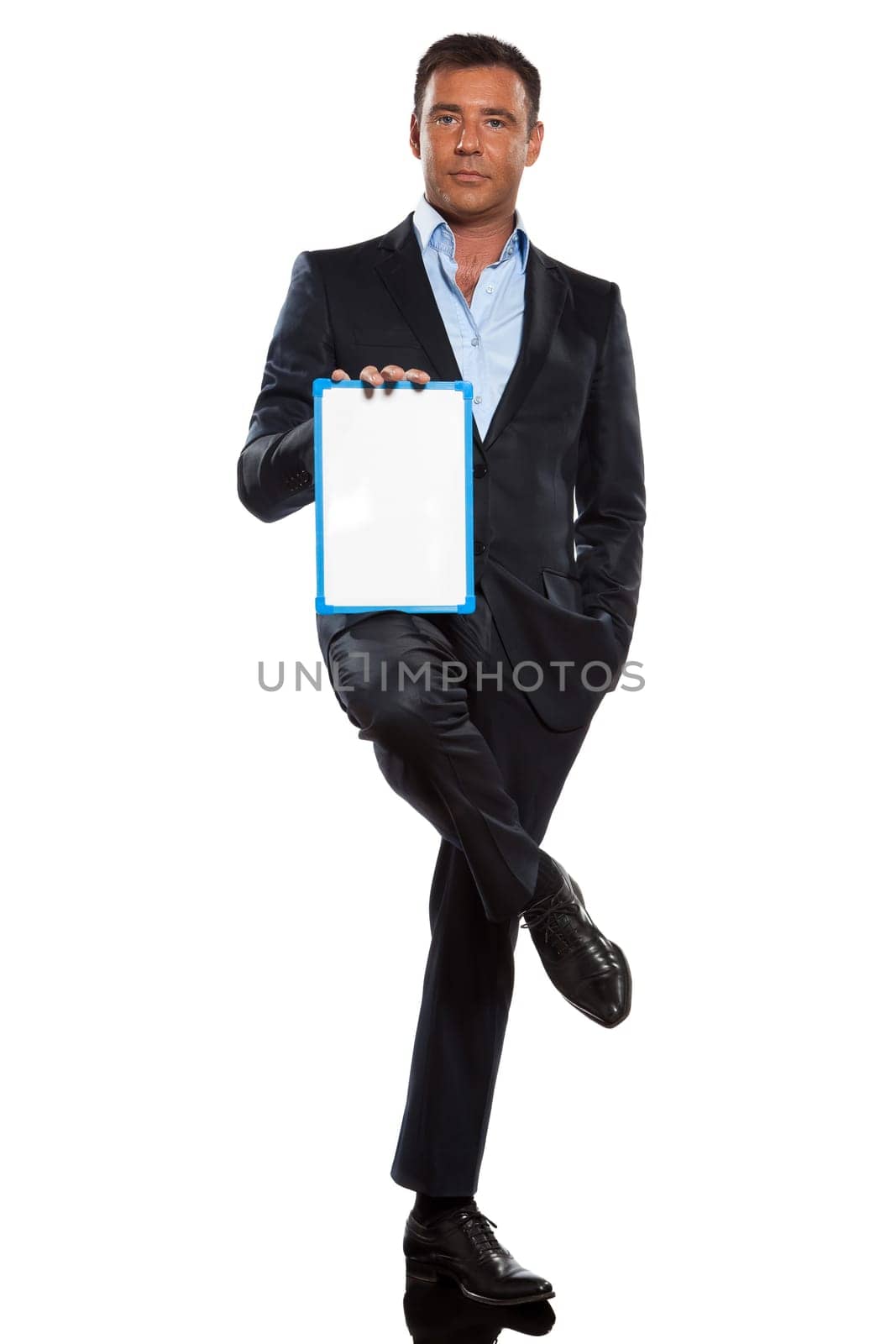one caucasian business man holding showing whiteboard full length in studio isolated on white background
