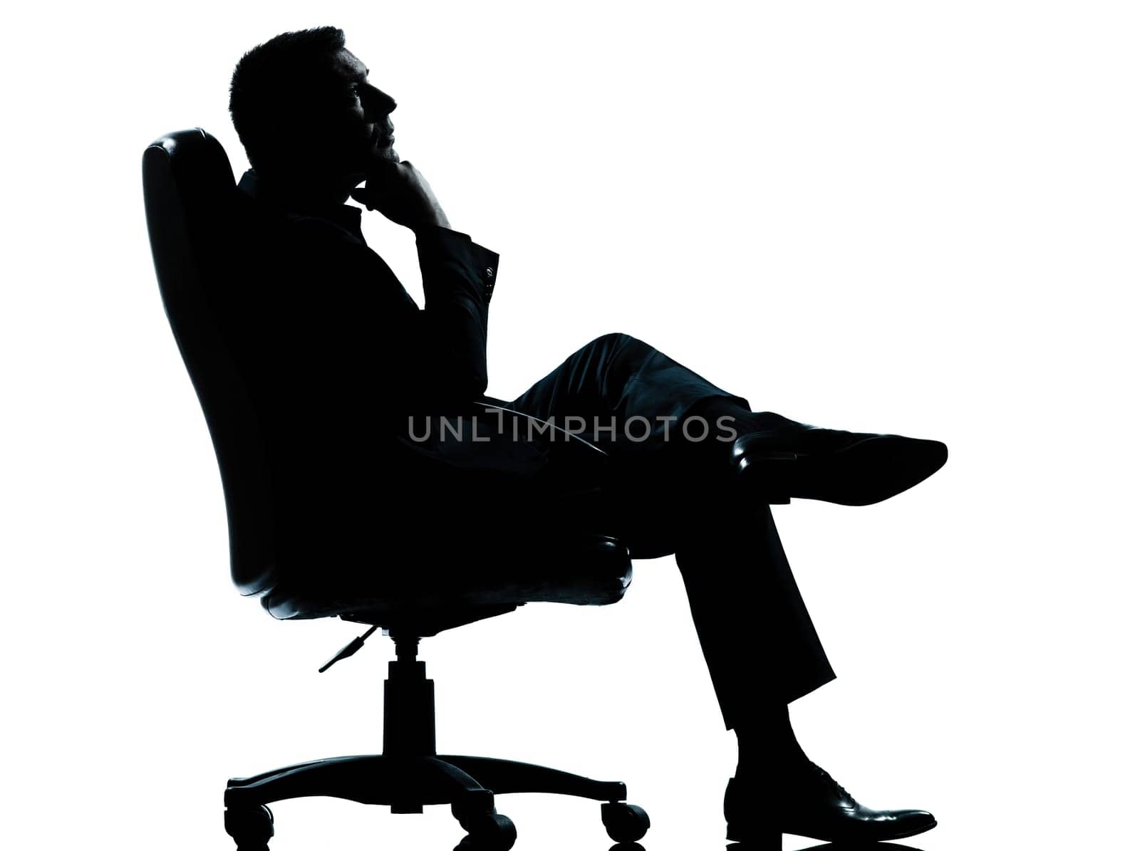 one caucasian business man relaxing thinking sitting in armchair silhouette Full length in studio isolated on white background