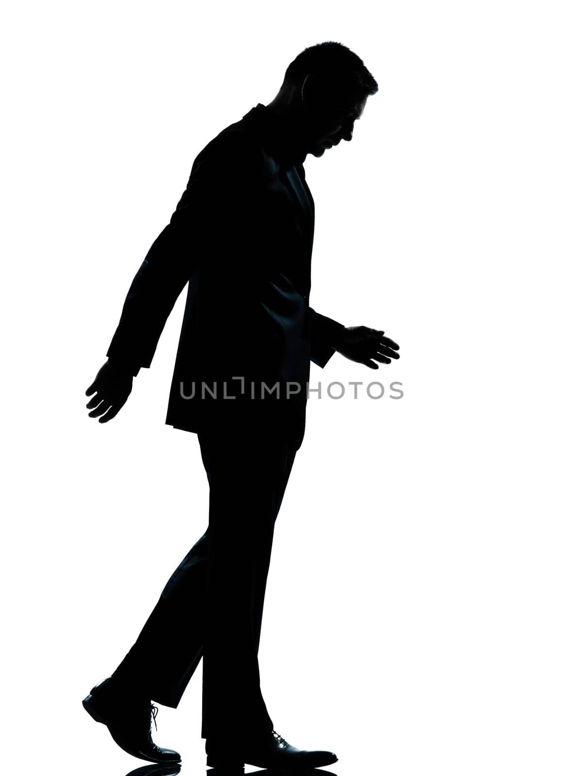 one caucasian business man walking silhouette Full length in studio isolated on white background