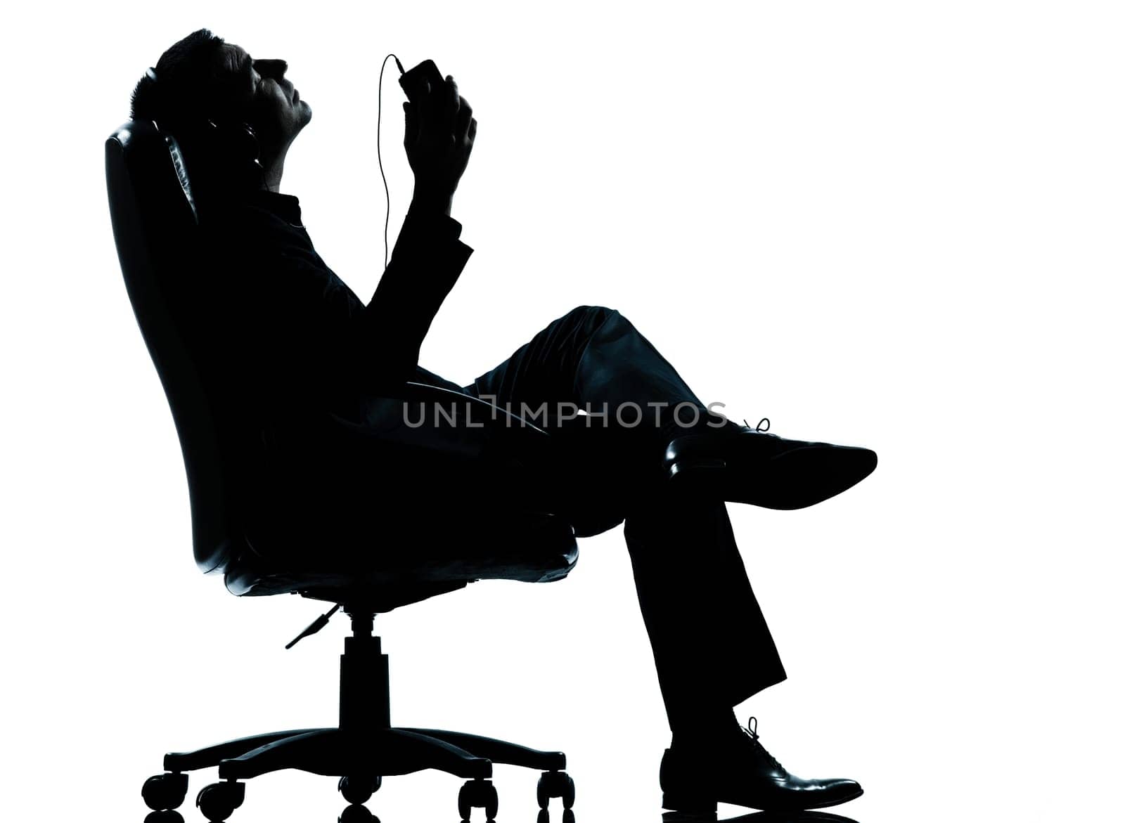 one caucasian business man listening music relaxing silhouette Full length in studio isolated on white background