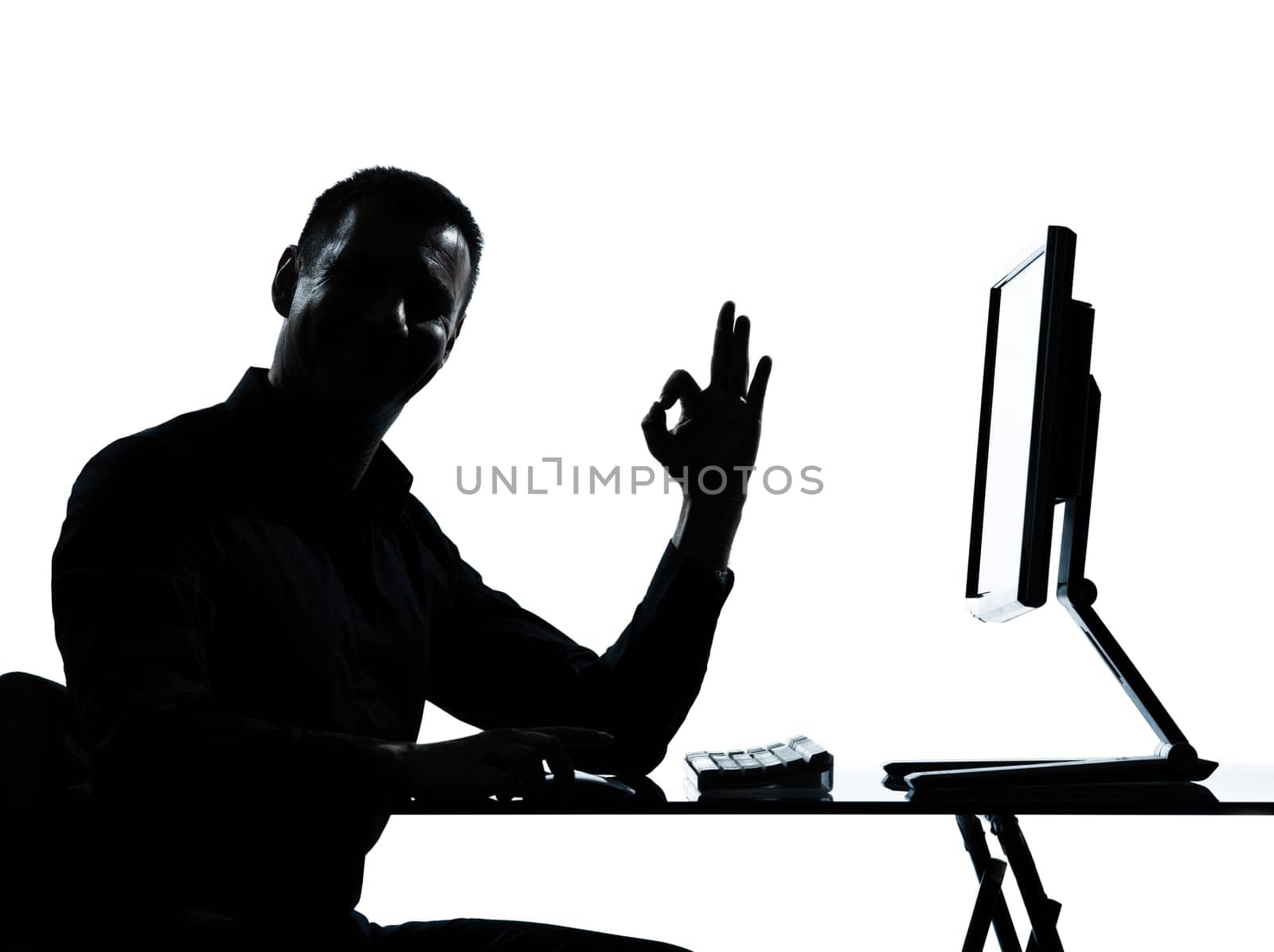one caucasian business man computer computing ok gesture silhouette in studio isolated on white background