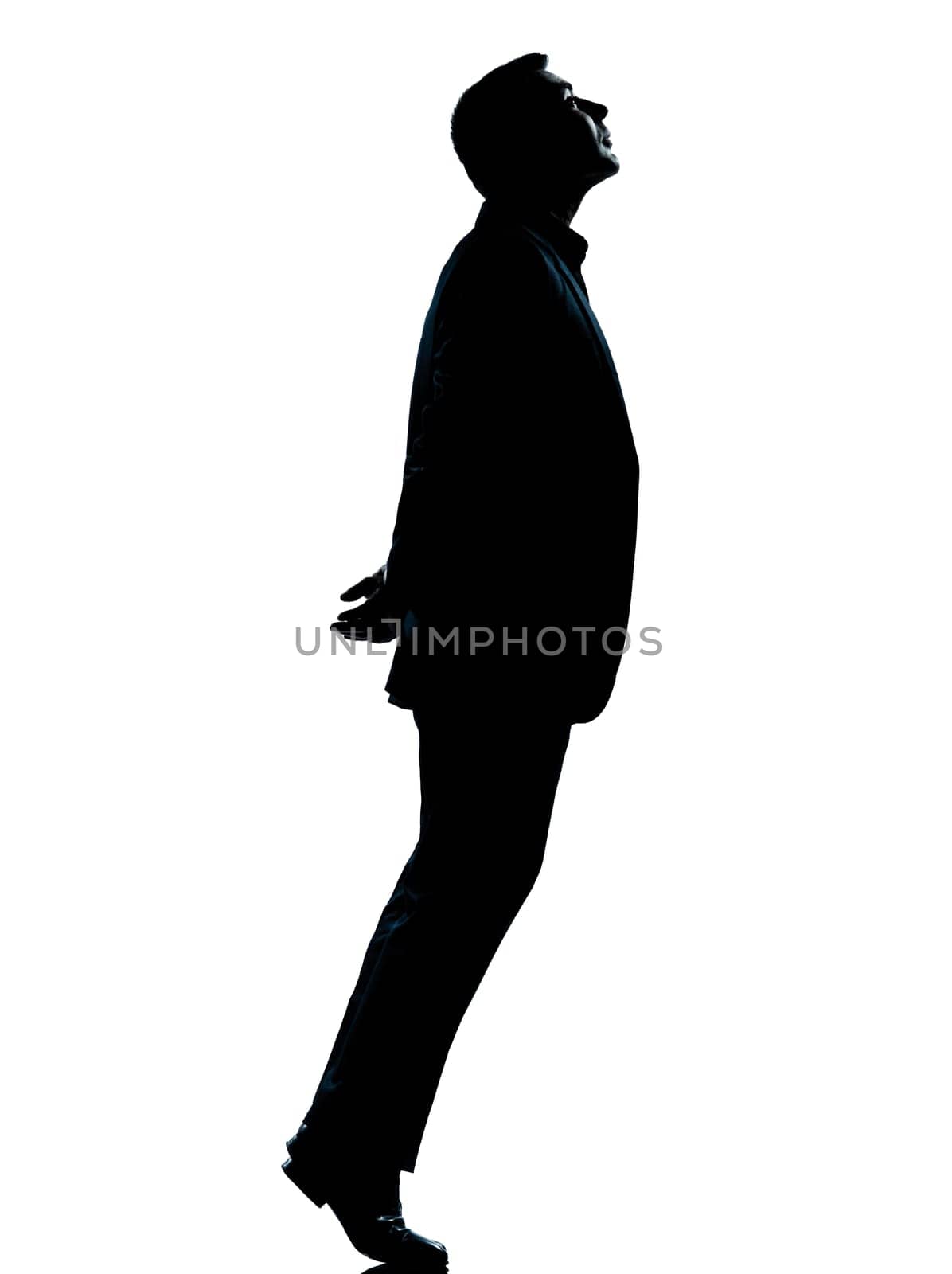 one caucasian business man silhouette standing tiptoe looking up Full length in studio isolated on white background