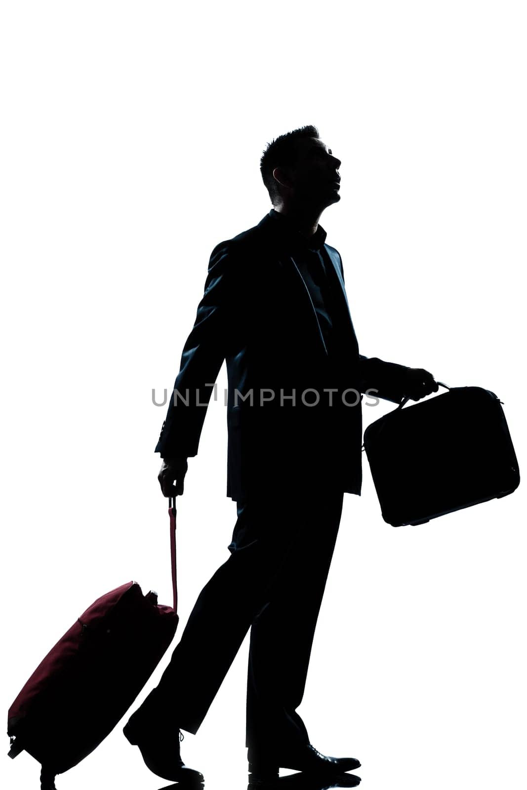 one caucasian business traveler man walking with suitcase lost looking up  full length silhouette in studio isolated white background