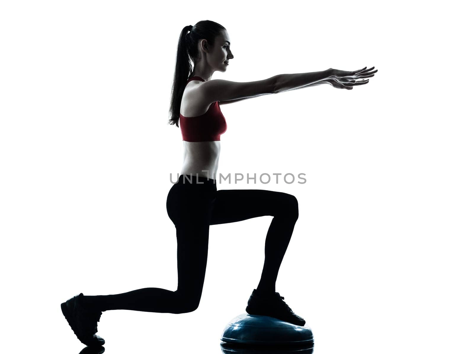one caucasian woman exercising bosu balance ball trainer in silhouette studio isolated isolated on white background