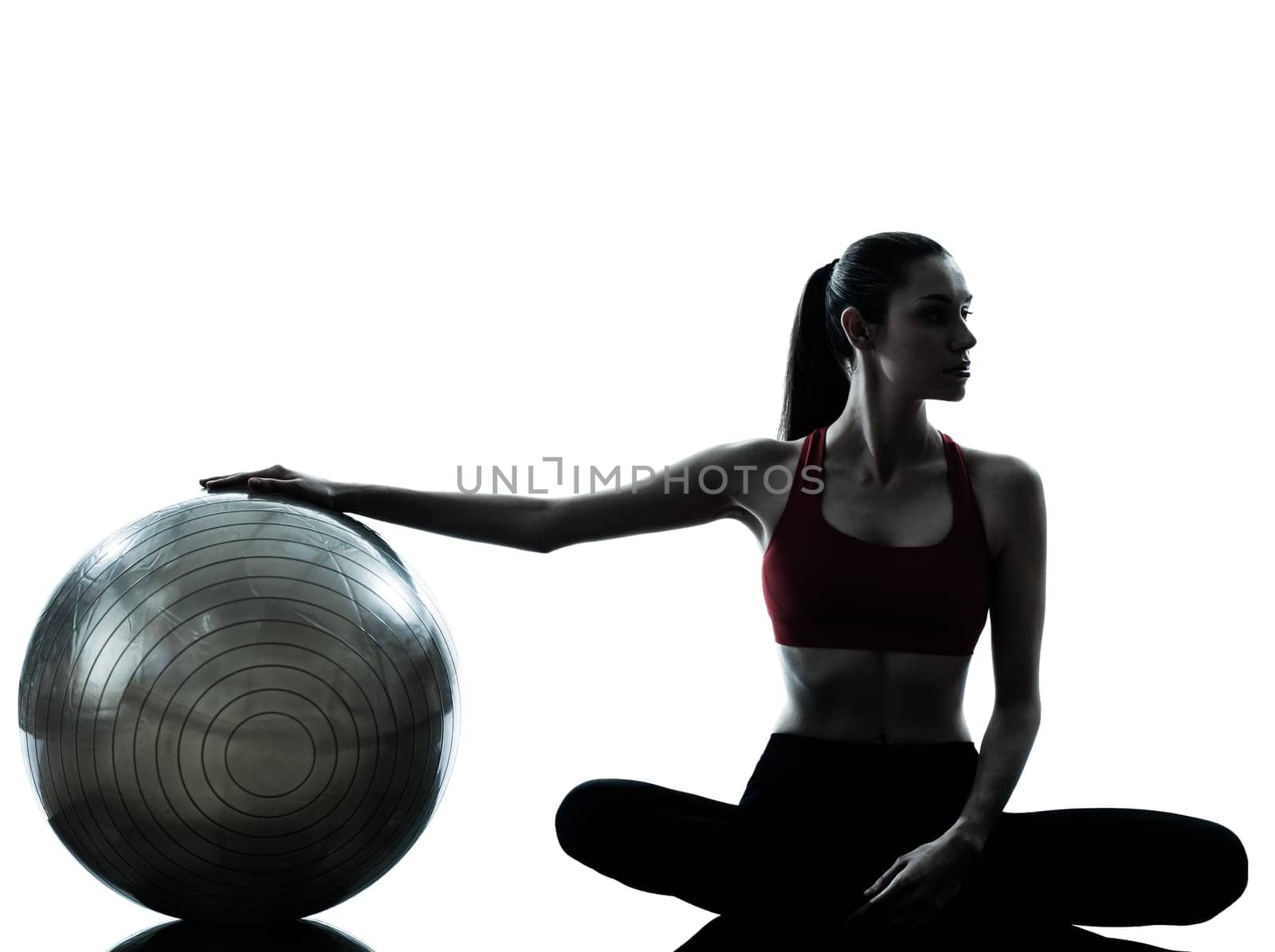 one caucasian woman exercising fitness ball in silhouette studio isolated on white background