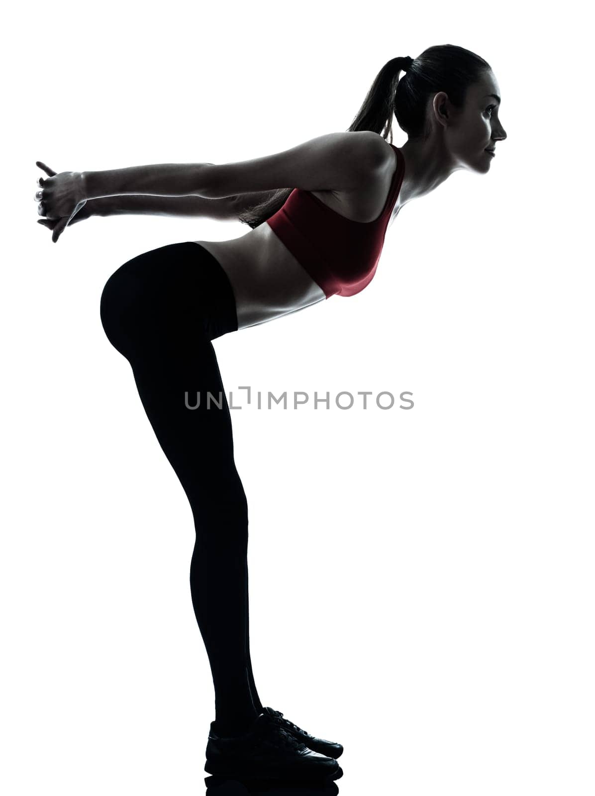 one caucasian woman exercising stretching arms in silhouette studio isolated isolated on white background