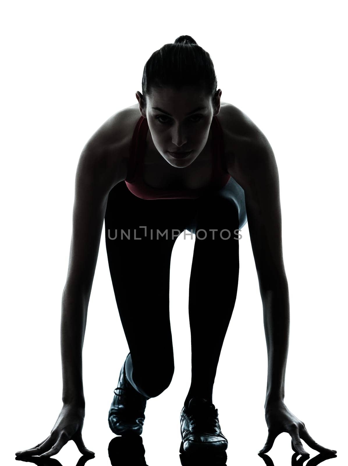 one caucasian woman sprinter on starting block in silhouette studio isolated on white background