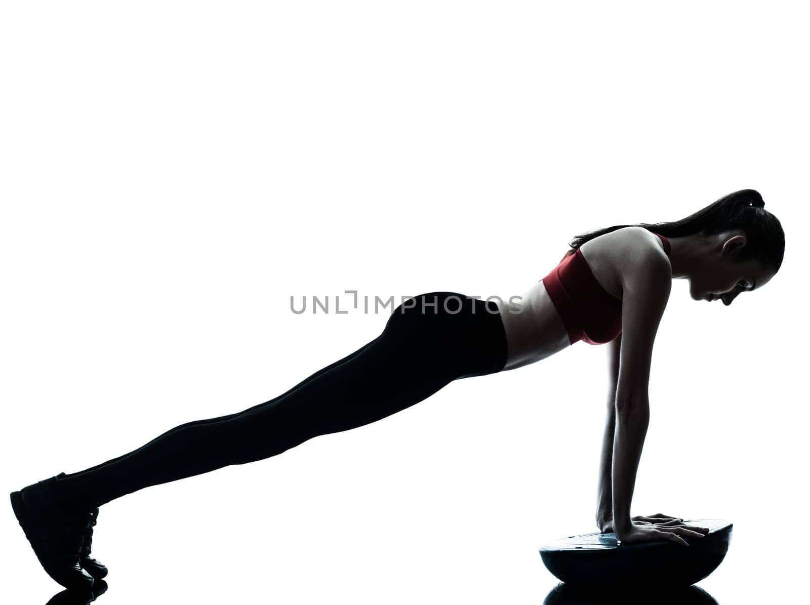 one caucasian woman exercising bosu balance ball trainer in silhouette studio isolated isolated on white background