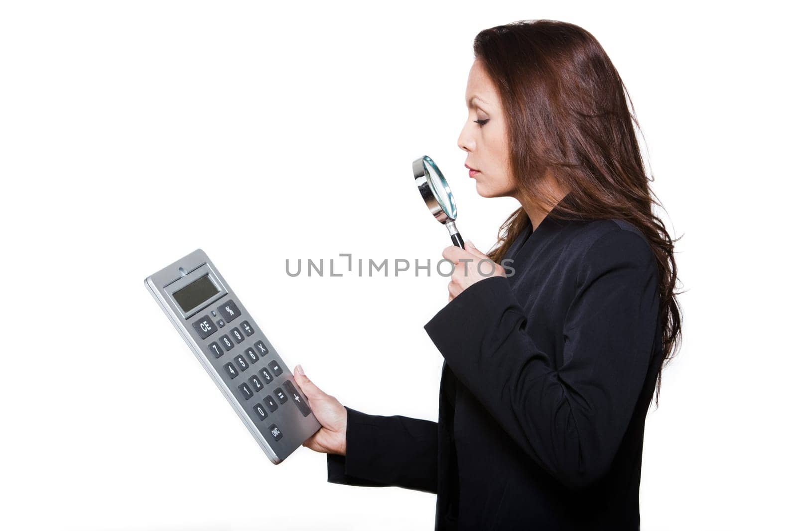 Portrait of woman with large calculator and magnifying glass in studio isolated on white background