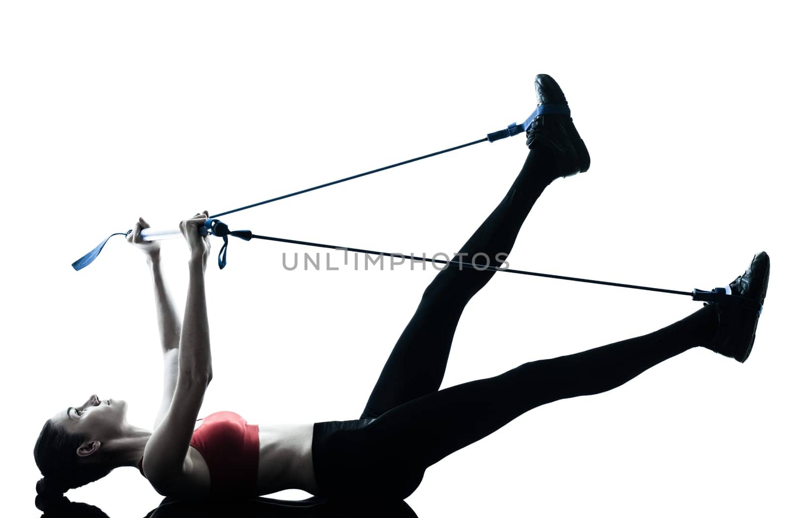 one caucasian woman exercising elastic gymstick in silhouette studio isolated on white background