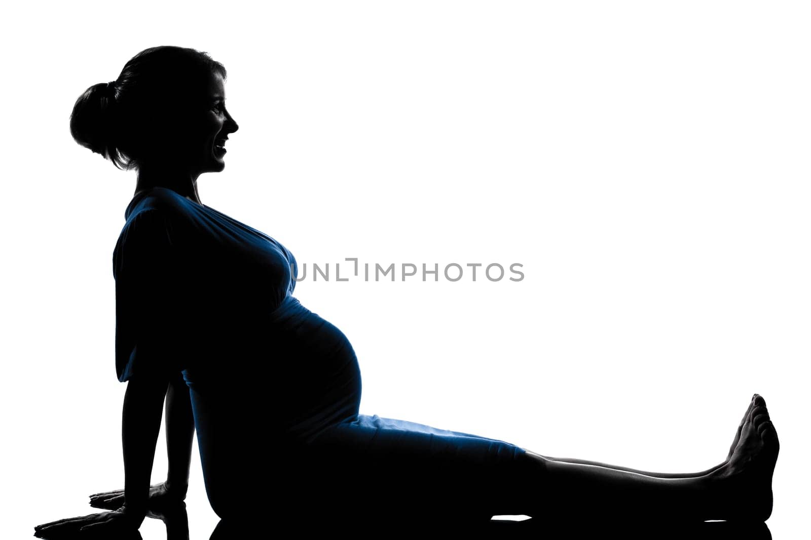 beautiful caucasian pregnant woman in silhouette on studio isolated white background