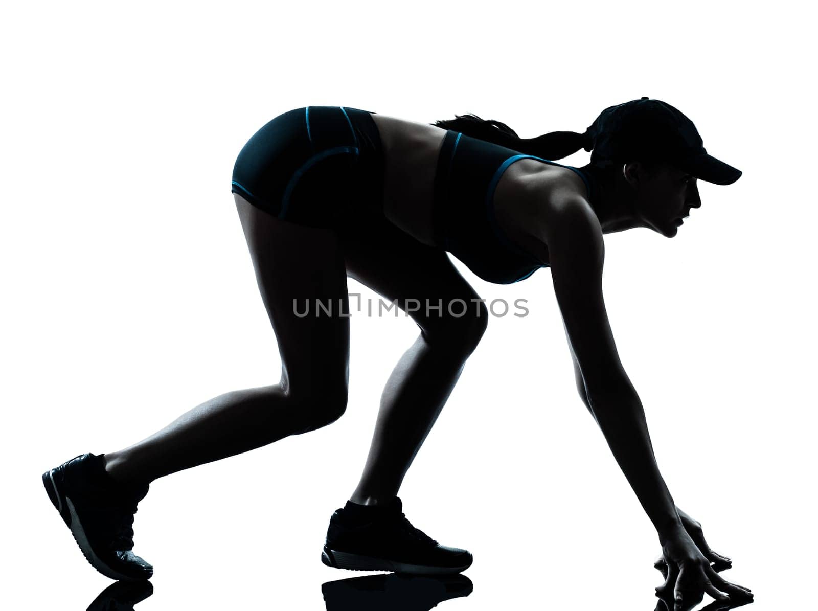 one caucasian woman runner jogger  on the starting block in silhouette studio isolated on white background