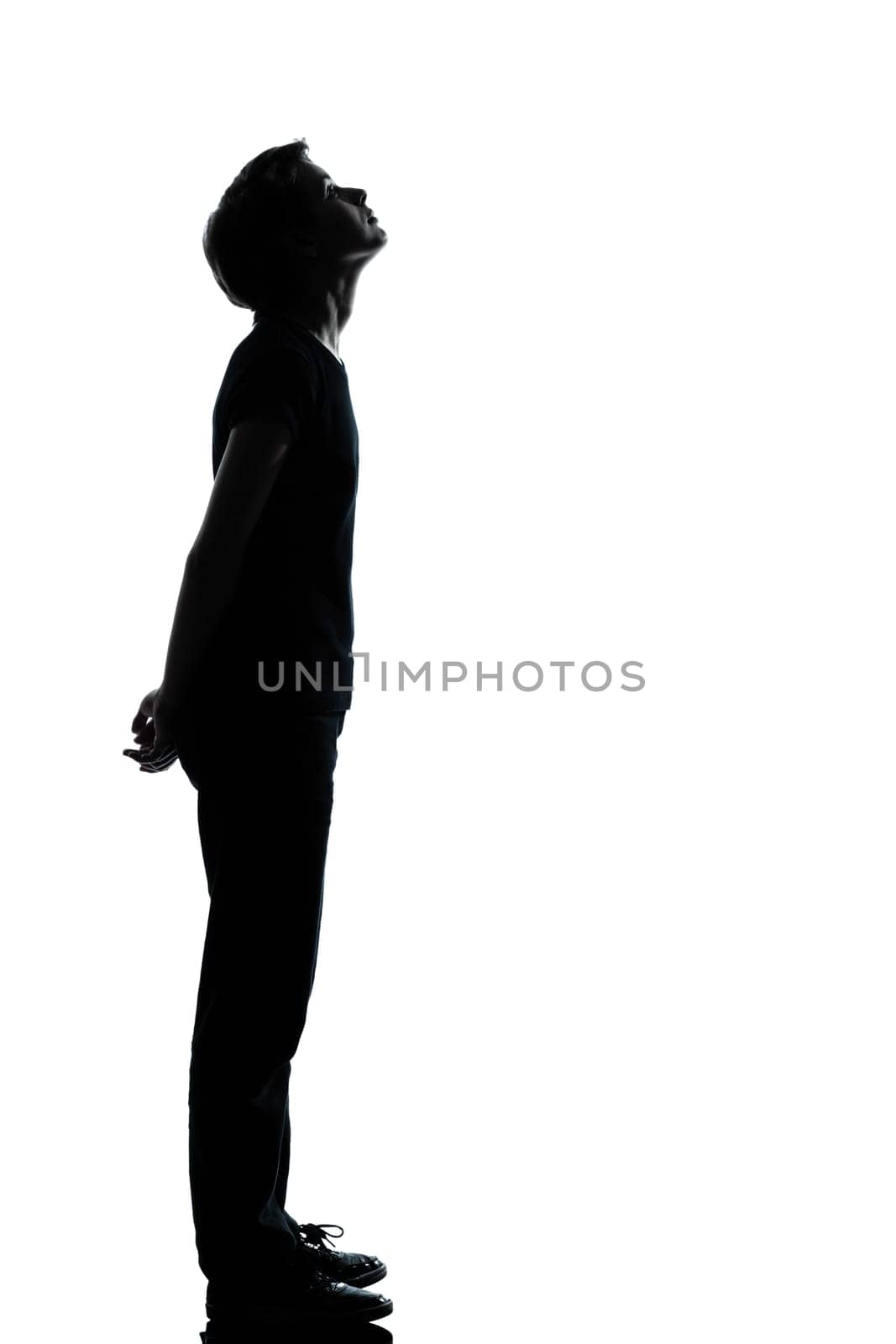one caucasian young teenager silhouette boy or girl full length in studio cut out isolated on white background