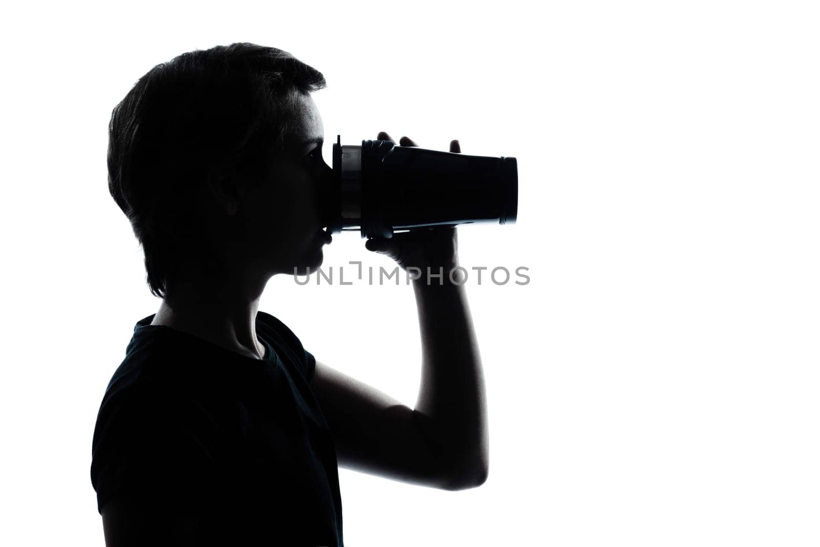 one caucasian young teenager drinking at thermos travel mug  silhouette boy or girl portrait in studio cut out isolated on white background