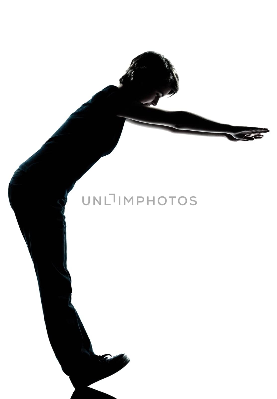 one caucasian young teenager silhouette boy or girl standing balancing on heels  full length in studio cut out isolated on white background