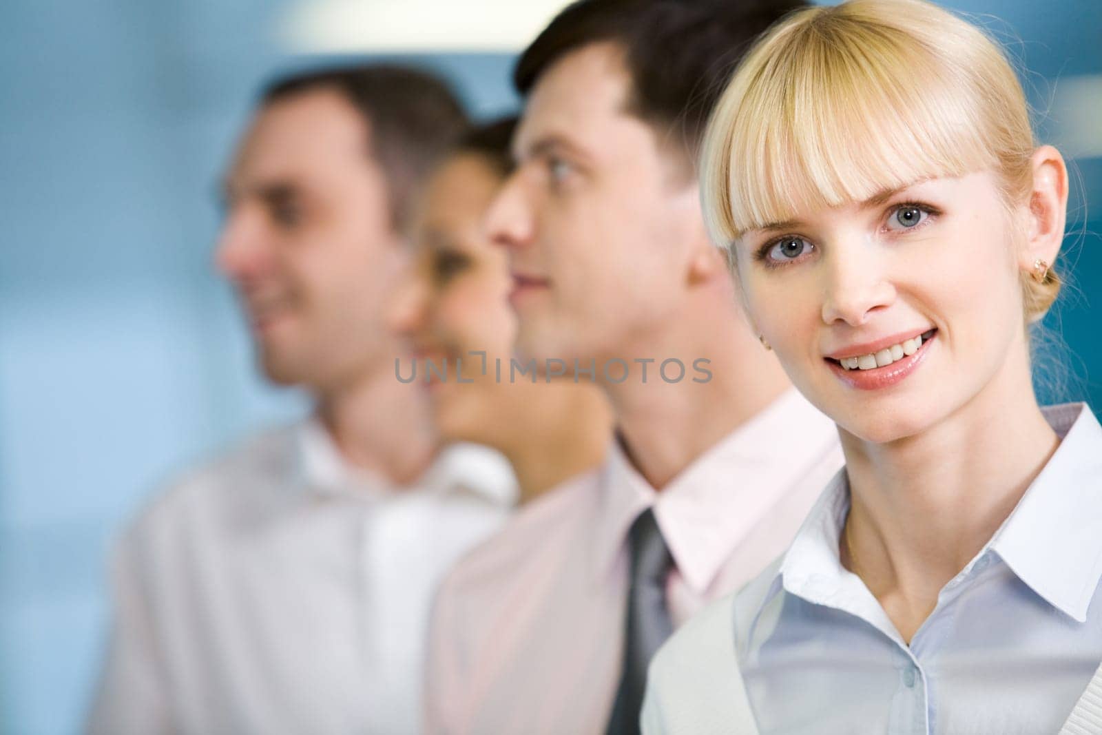 Image of business group standing in line with pretty female in front