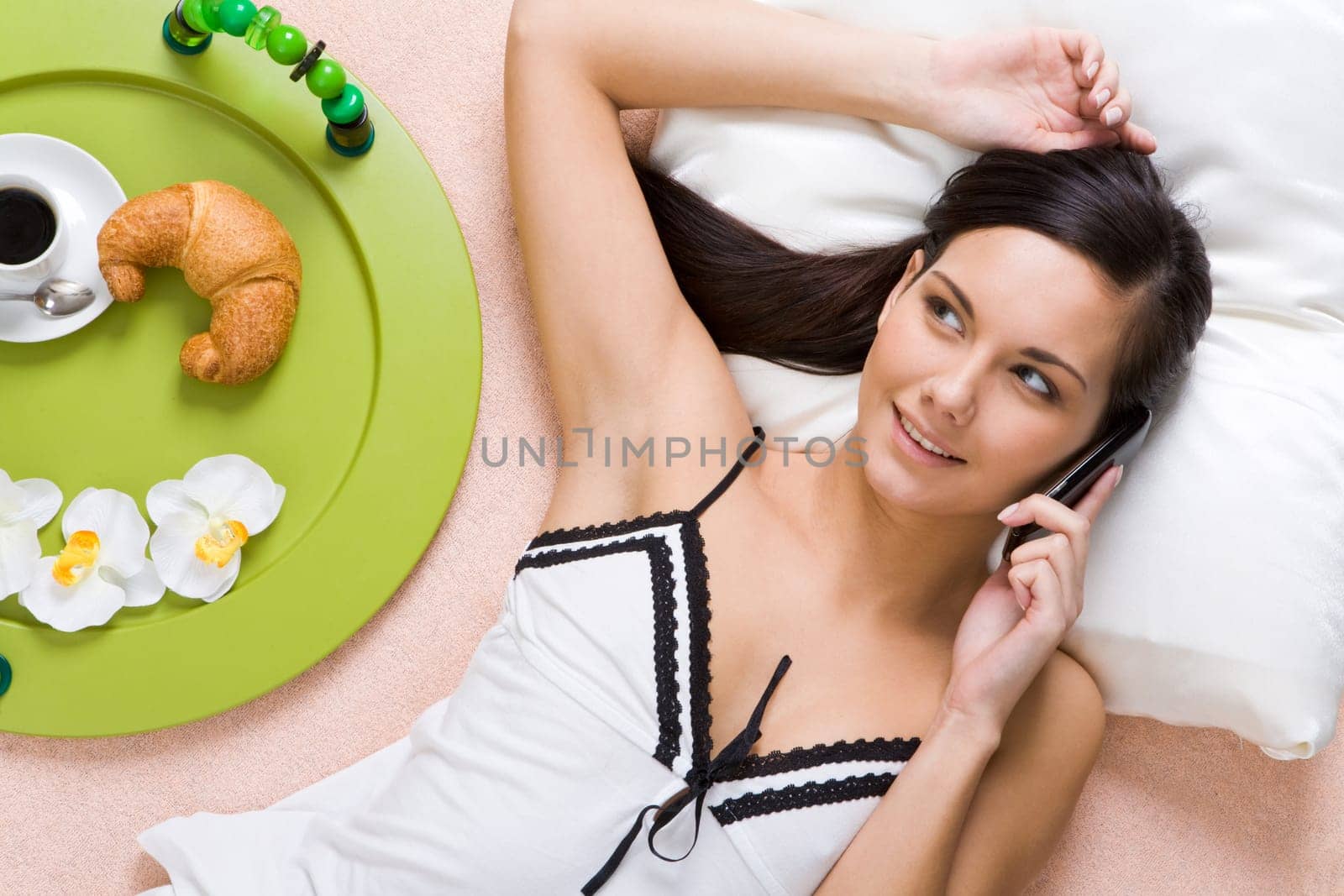 Close-up of smiling girl talking on cellular phone with her friend