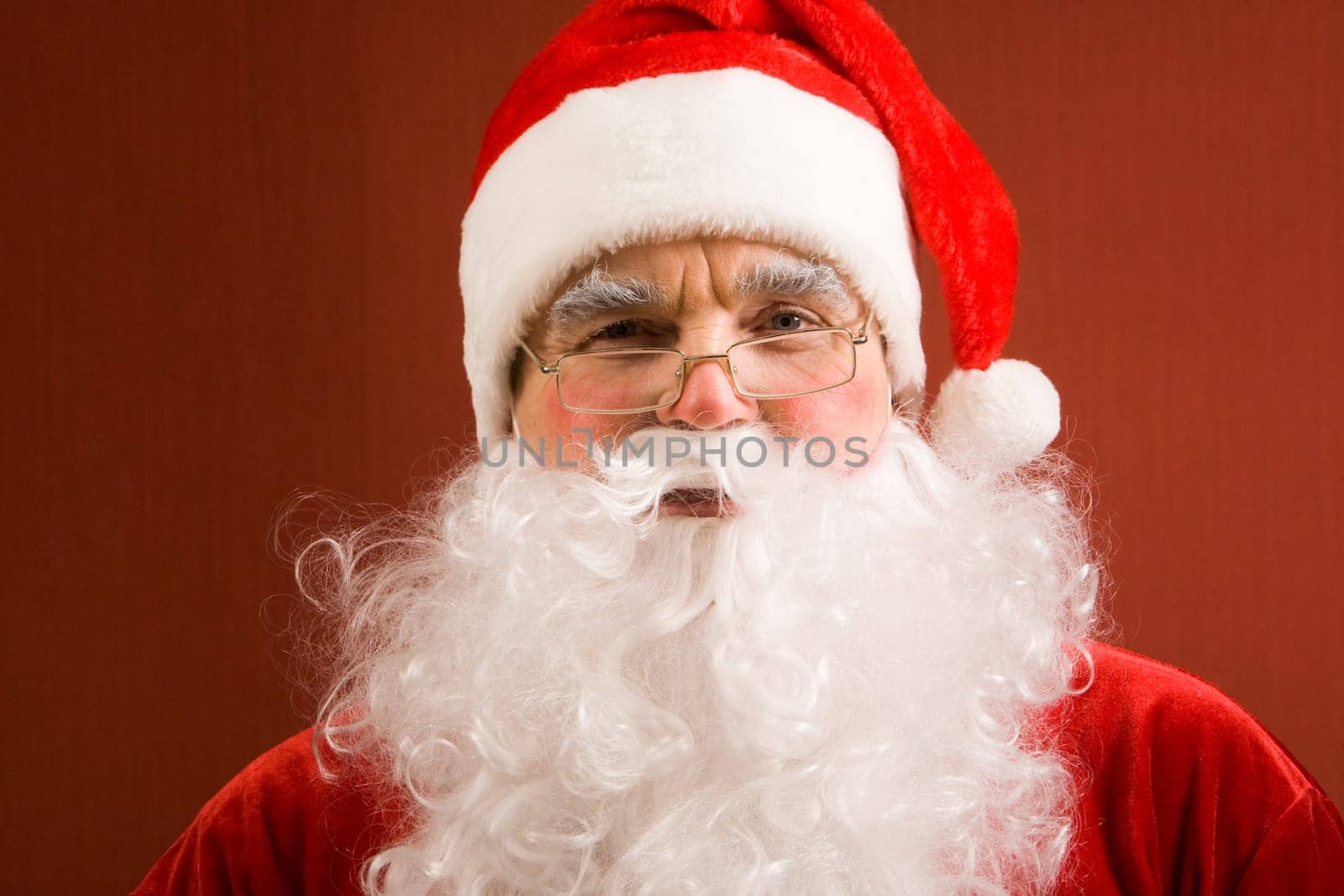 Photo of happy Santa Claus in eyeglasses looking at camera