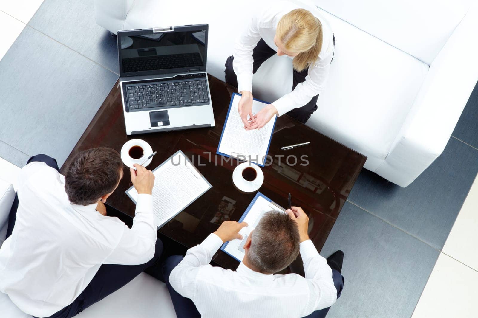 Photo of successful employees discussing business plan at meeting