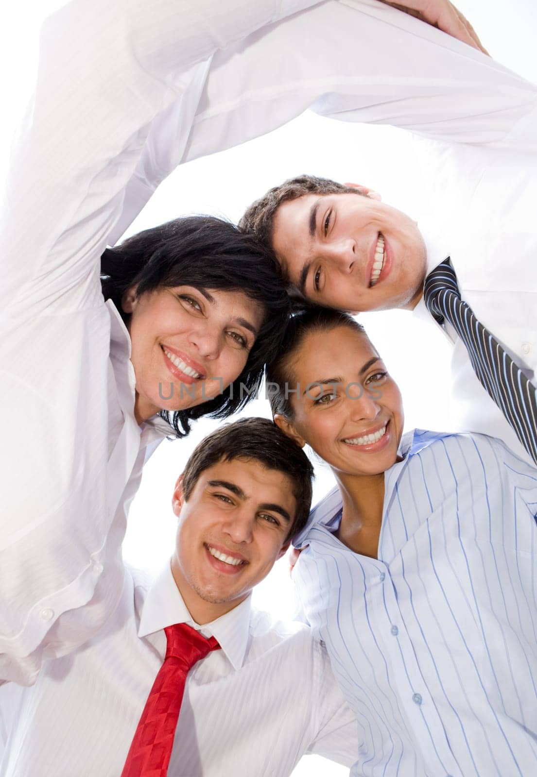 Portrait of smiling group in white shirts together looking at camera