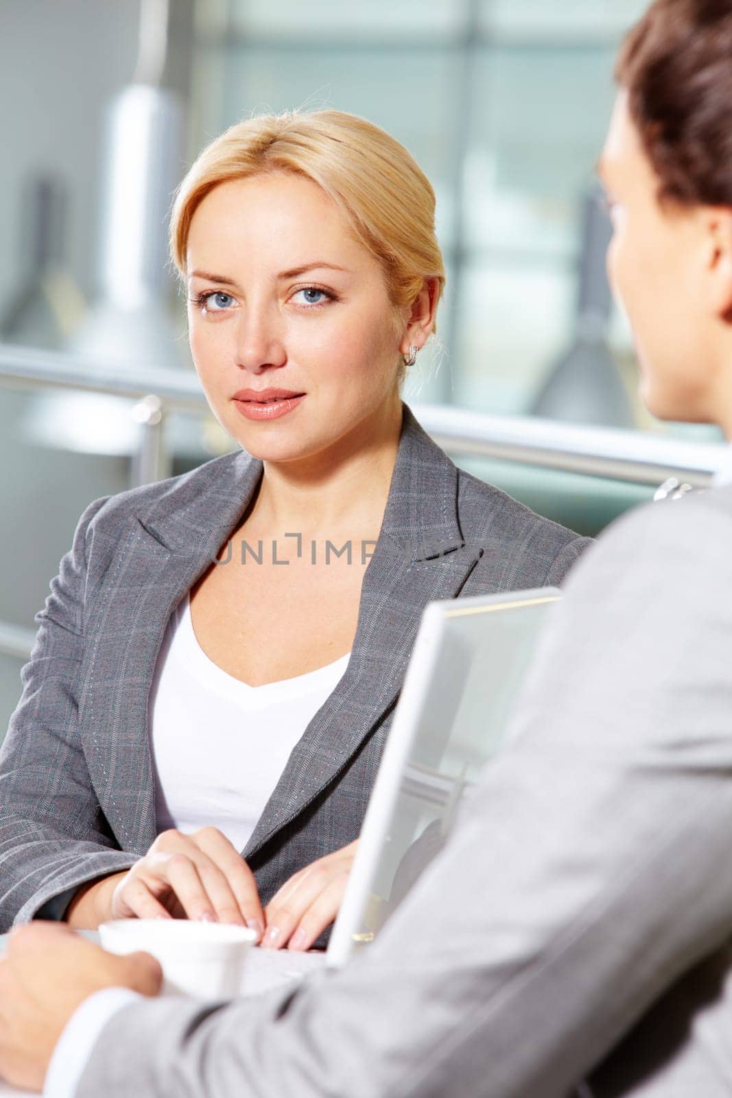 Portrait of pretty woman at workplace looking at camera