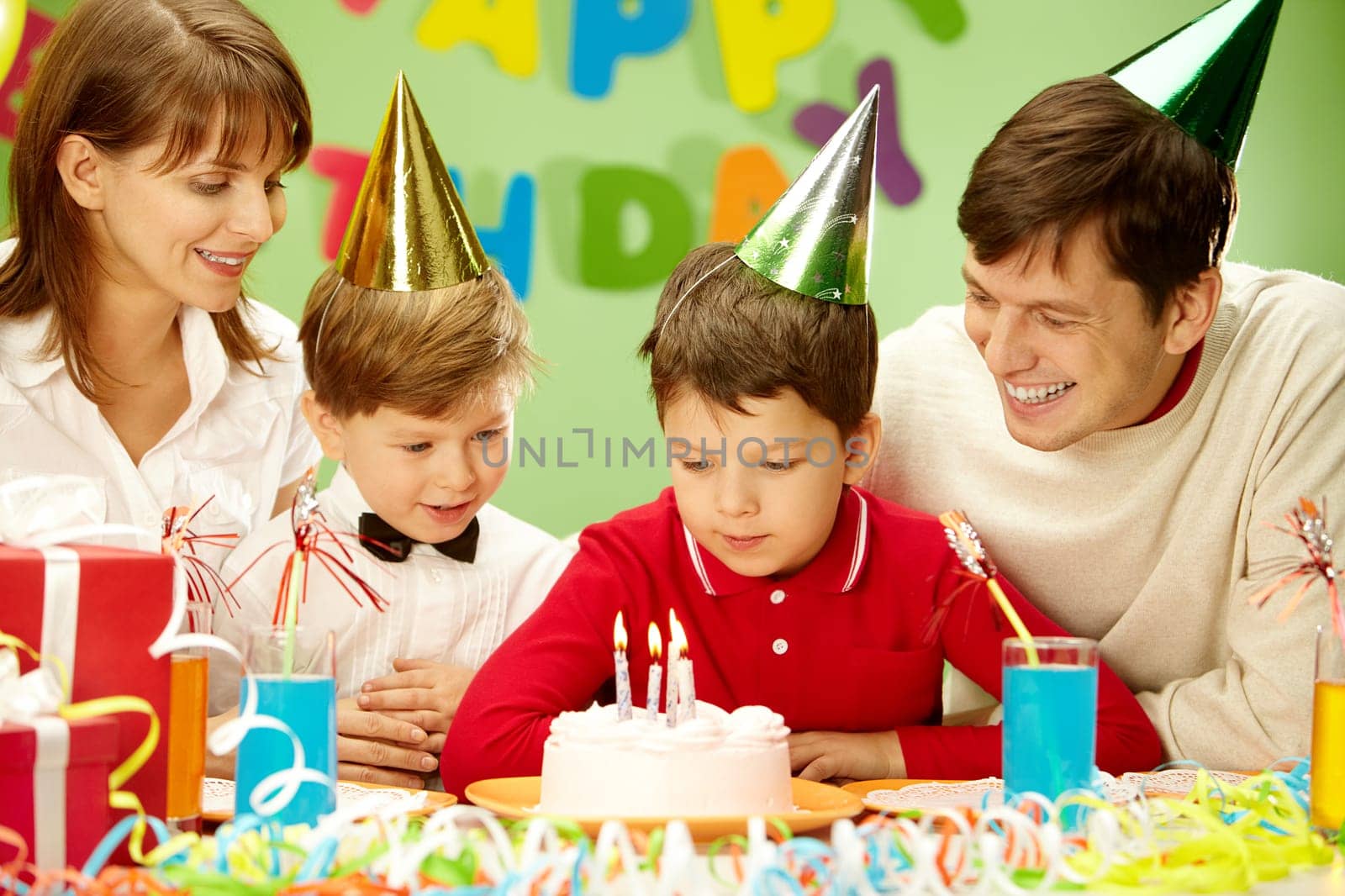 Portrait of family looking at holiday cake