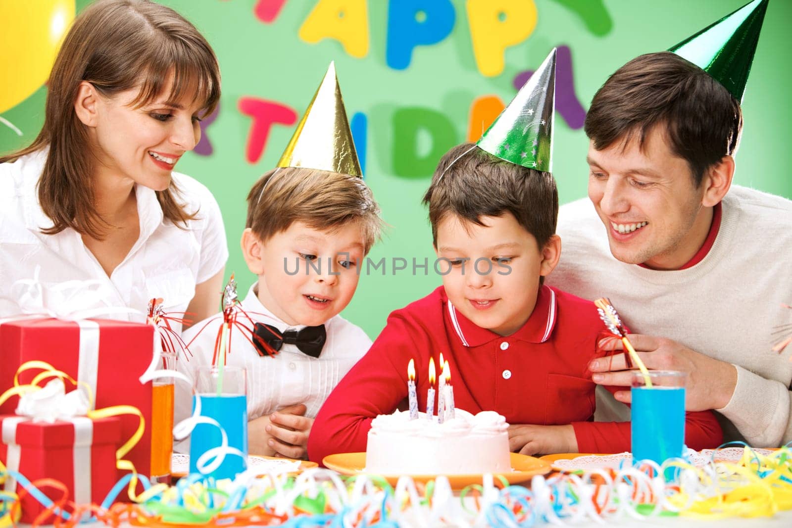 Portrait of family looking at holiday cake