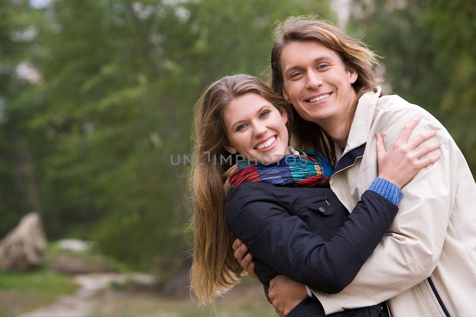 Portrait of affectionate couple embracing and having fun outdoors