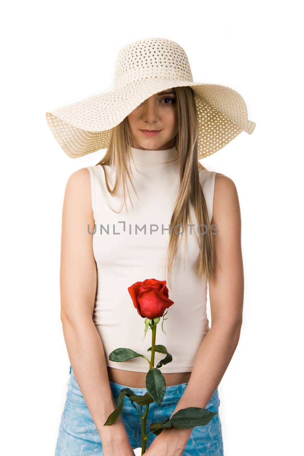 Portrait of elegant lady in hat wnd rose in hands over white background