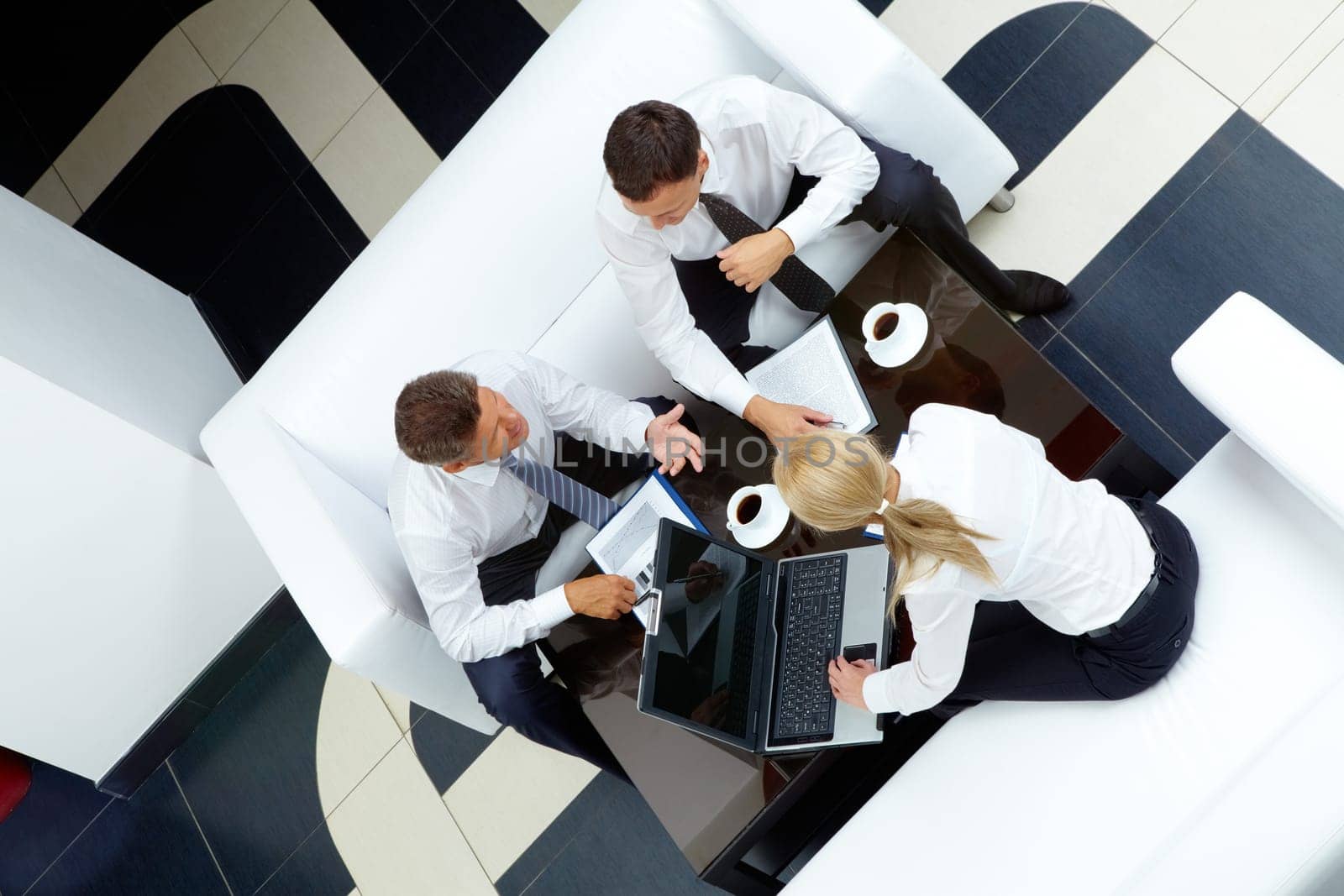 Photo of successful employees discussing business plan at meeting