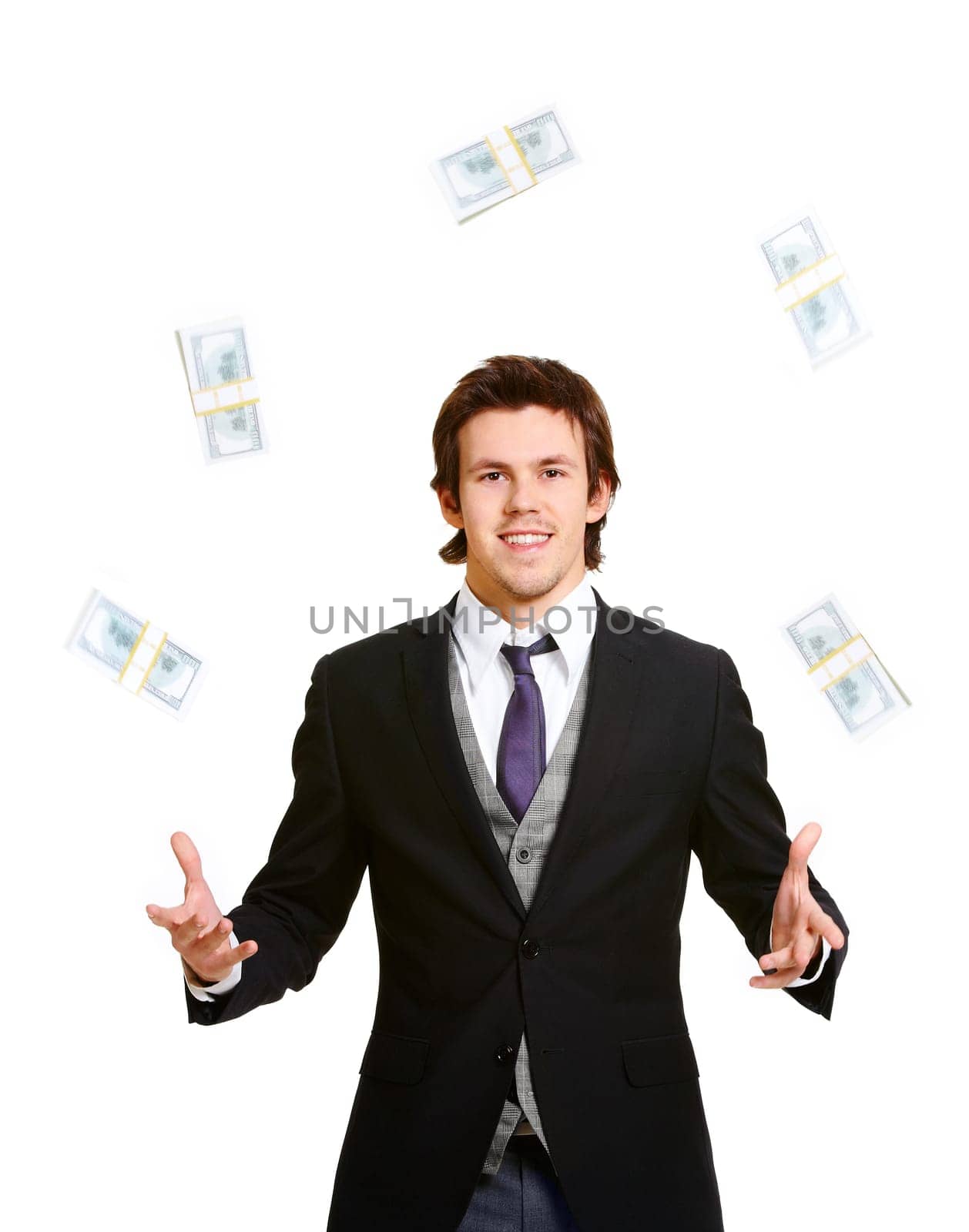 Portrait of successful businessman joggling dollars