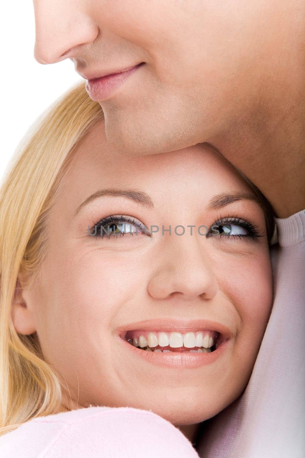 Face of laughing girl looking aside on her boyfriend shoulder