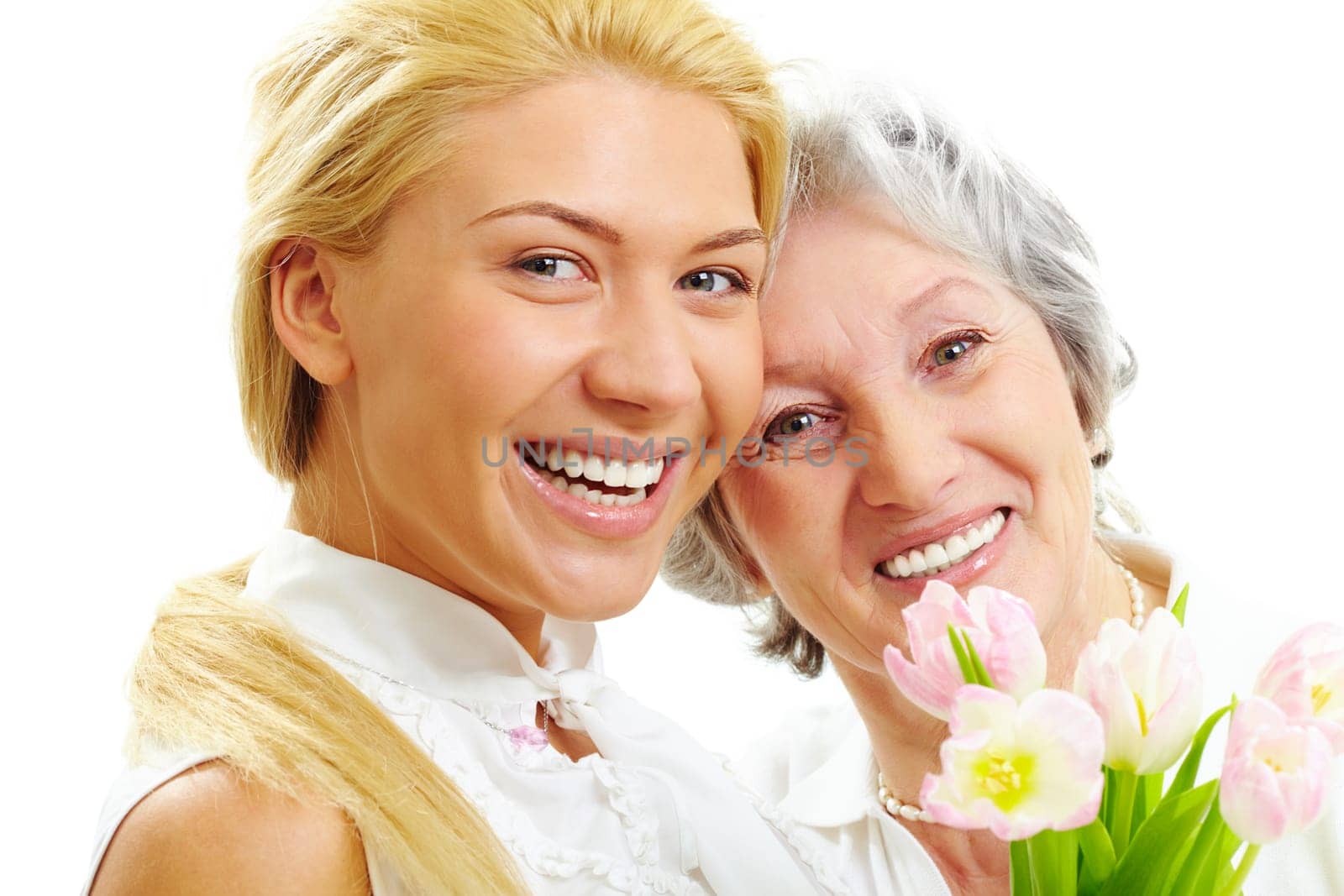 Portrait of happy woman and her senior mother looking at camera