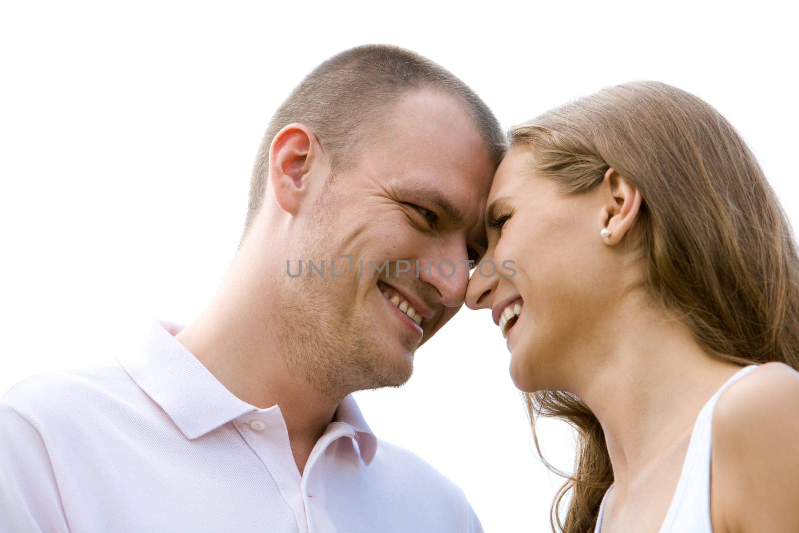 Close-up of happy couple laughing while touching by noses