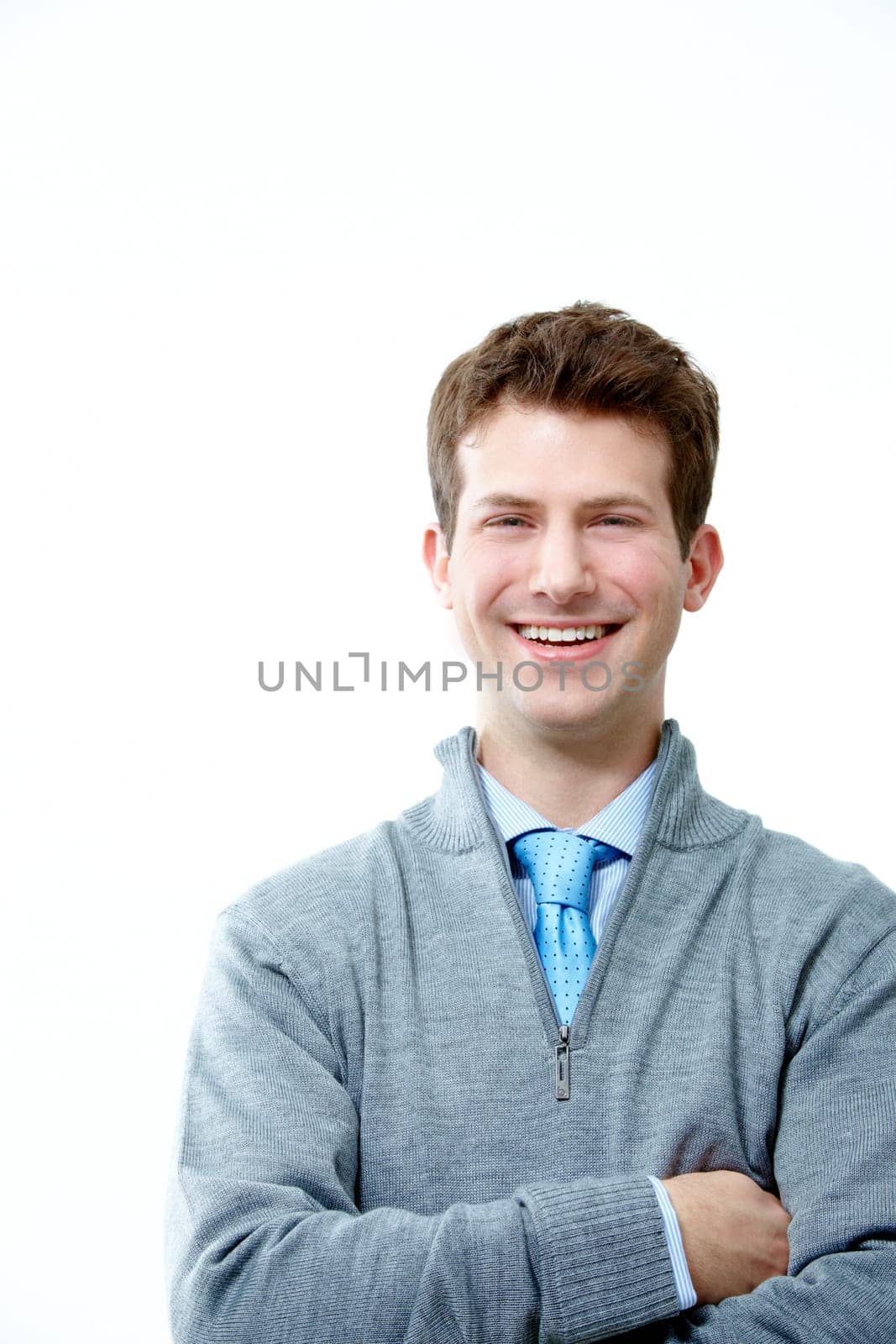 Portrait of young handsome businessman with crossed arms looking at camera