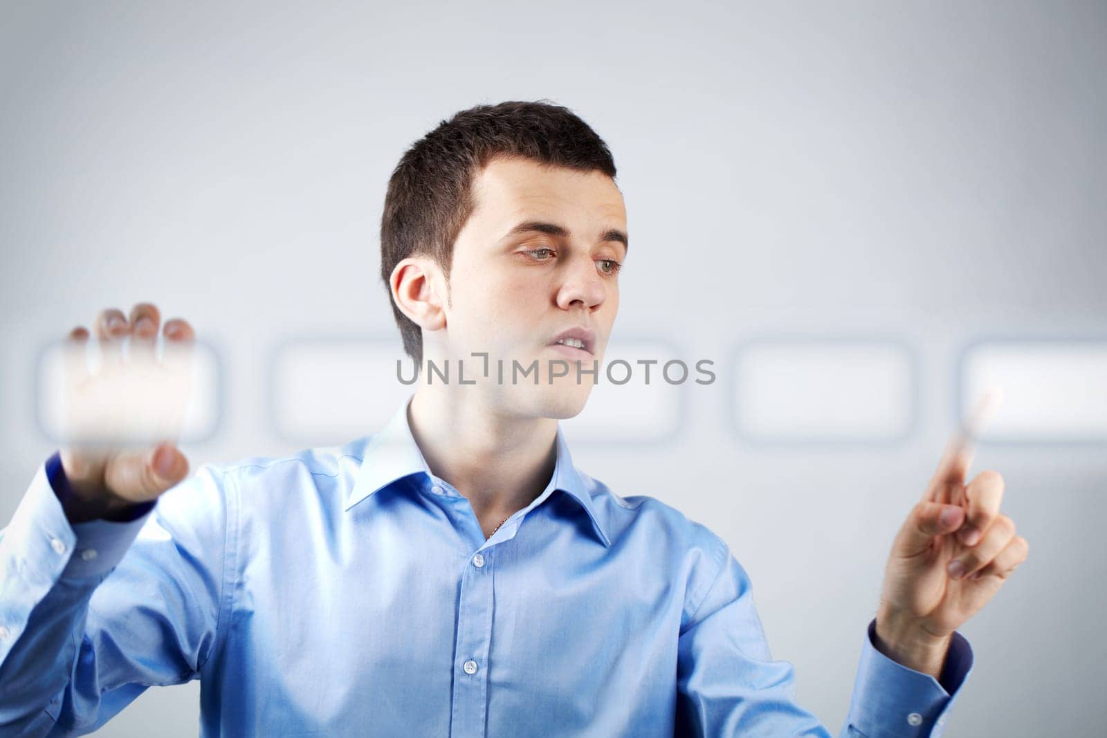 Image of businessman holding and pressing virtual button