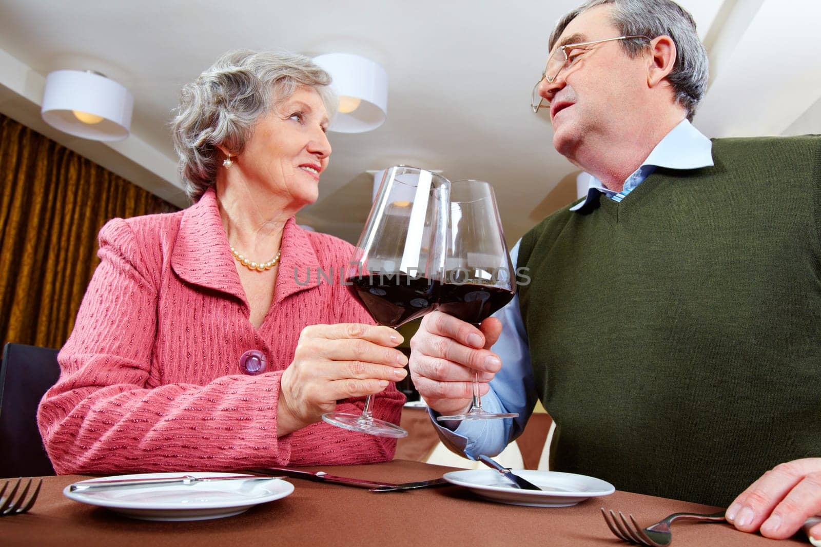 Image of couple looking at each other and drinking for love