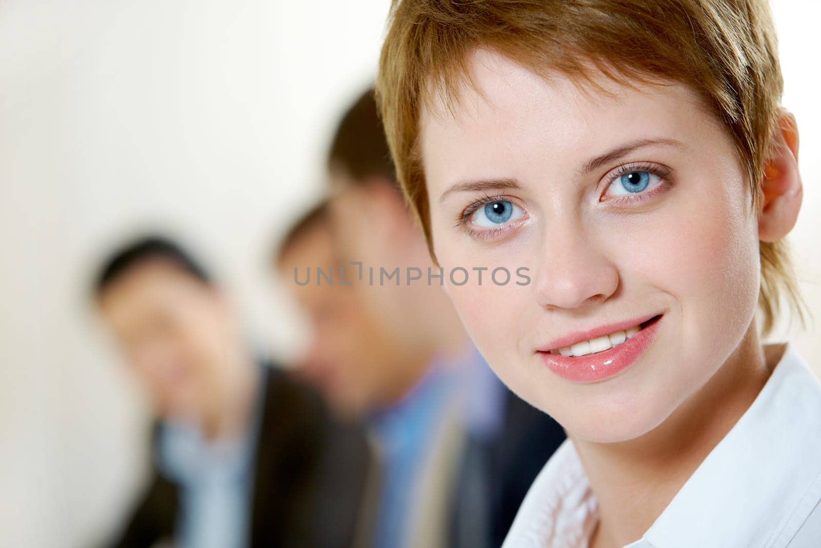 Image of pretty business woman looking at camera in working environment
