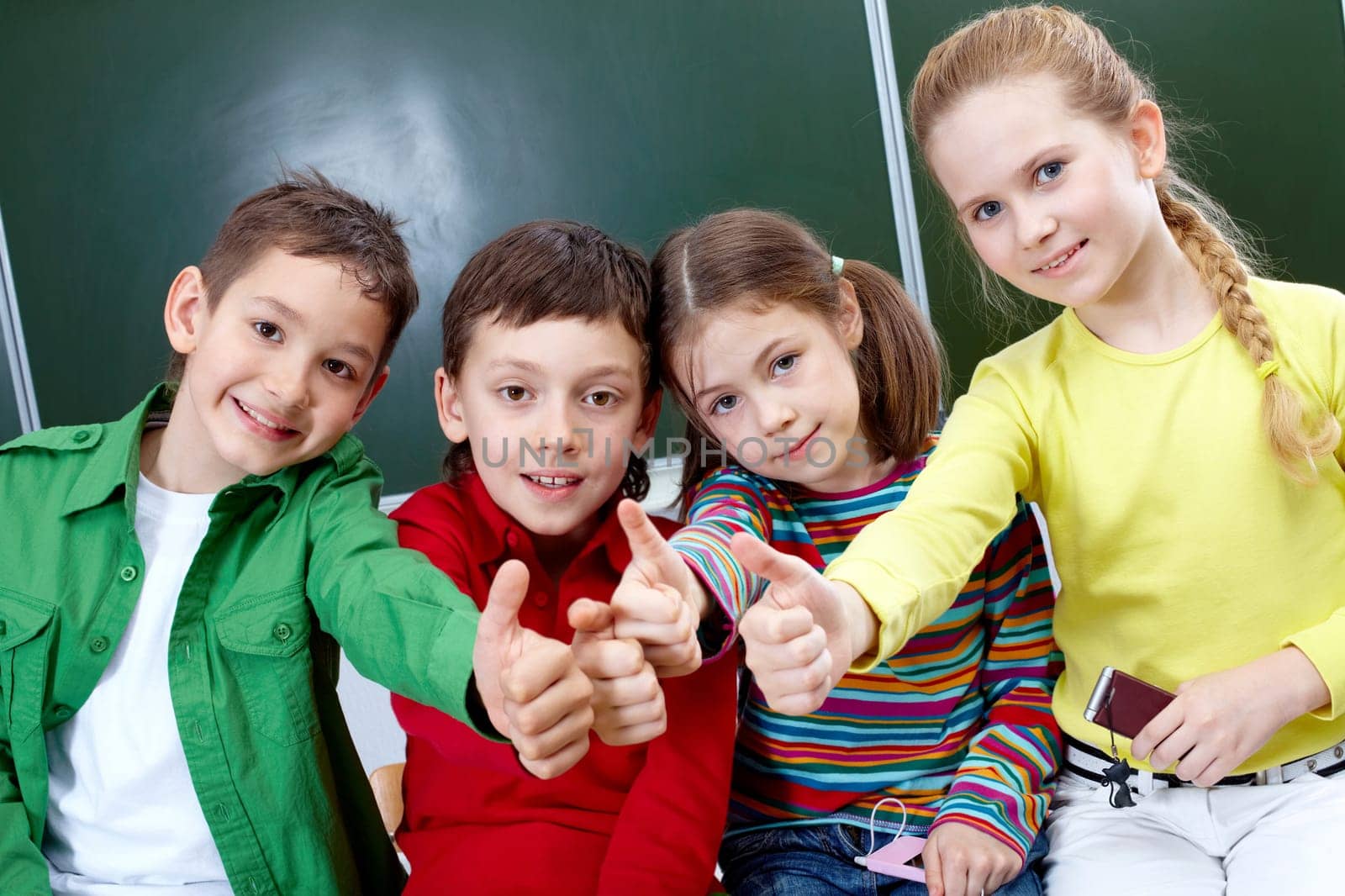 Group of four classmates showing sign of ok