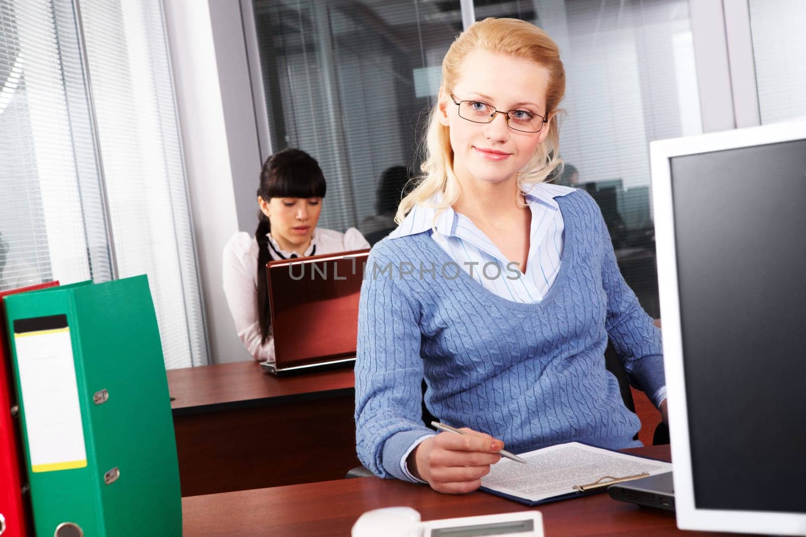 Pretty secretary doing paperwork in the office