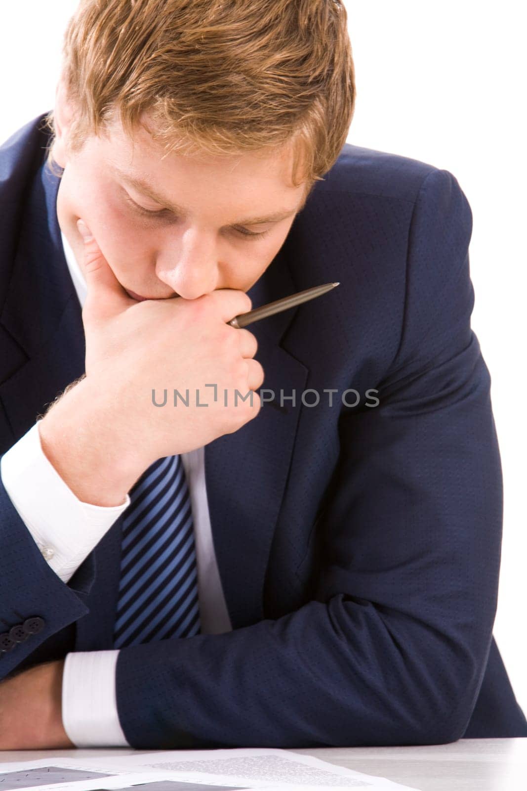 Portrait of thoughtful businessman looking at documents while planning work
