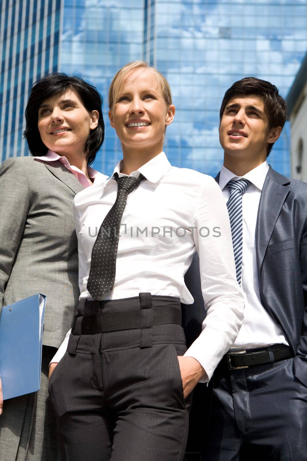 Portrait of confident business group looking at camera with pretty blonde at foreground