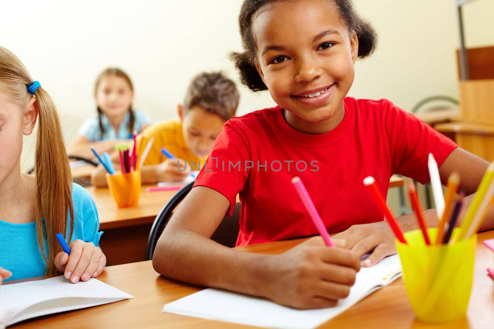 Portrait of lovely girls looking at camera at lesson