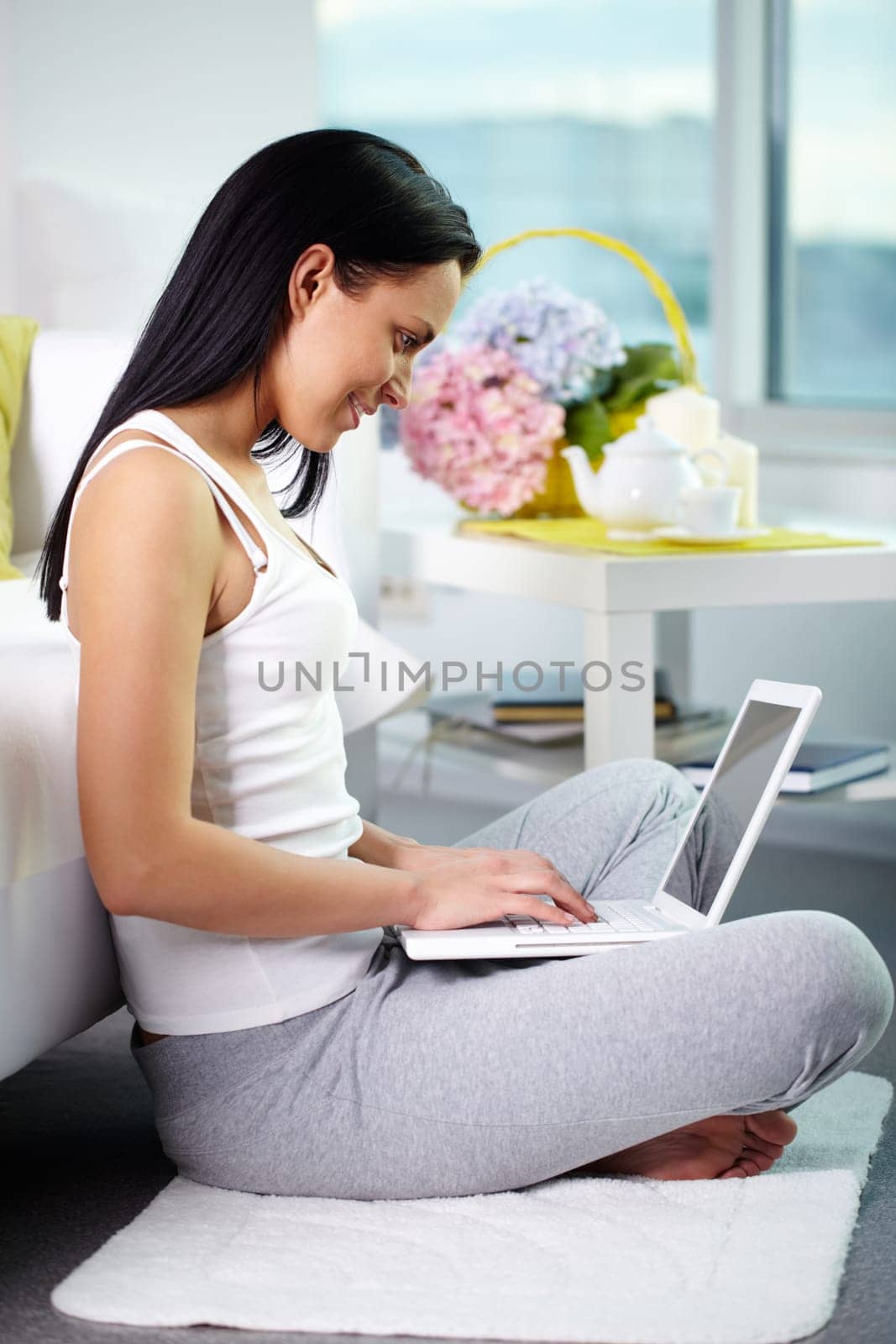 Portrait of pretty brunette typing at home