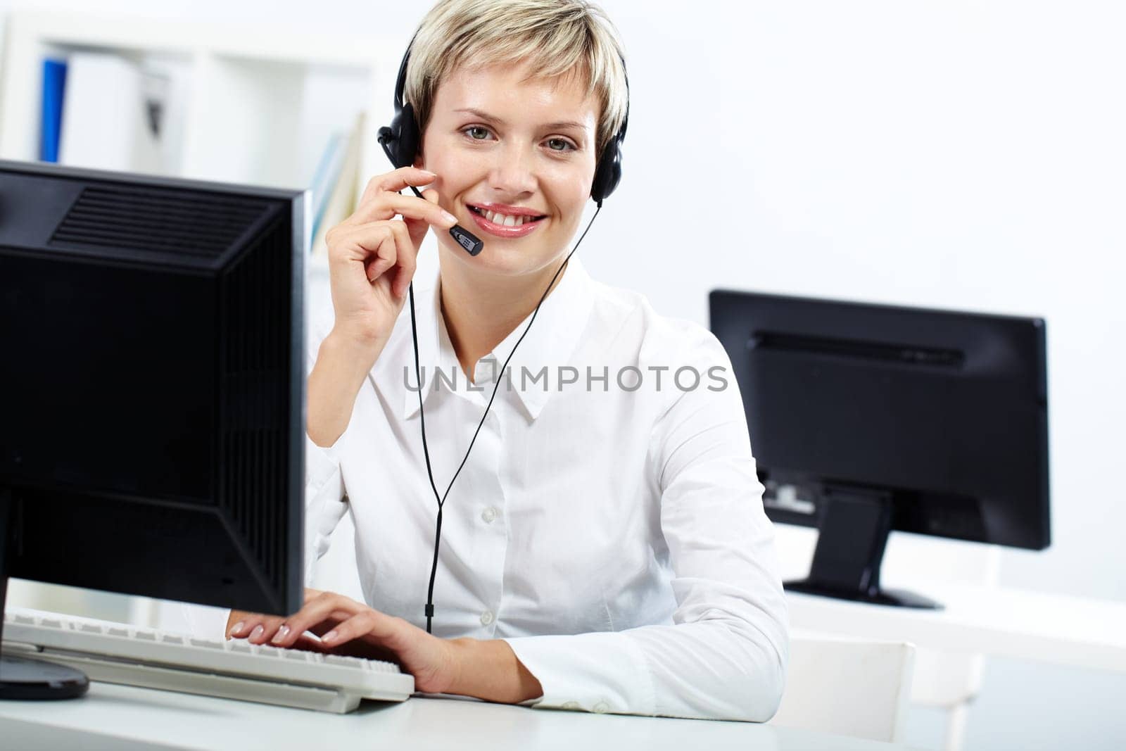 Portrait of young blond secretary looking at camera and smiling